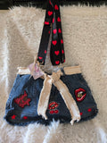 Handmade jean purse with lots of pockets on the outside with lots of red