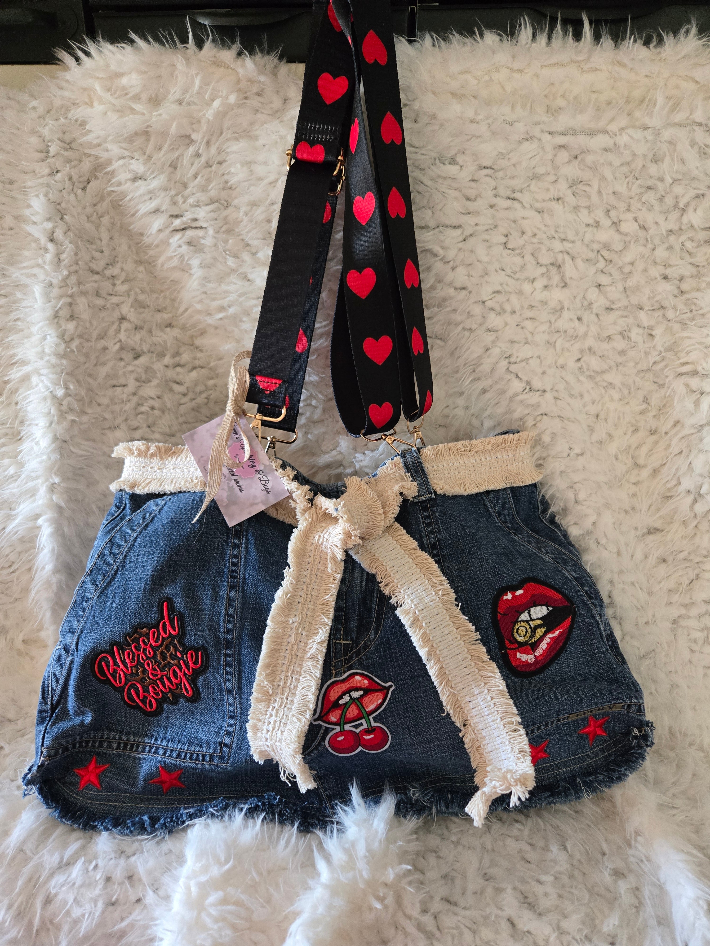 Handmade jean purse with lots of pockets on the outside with lots of red