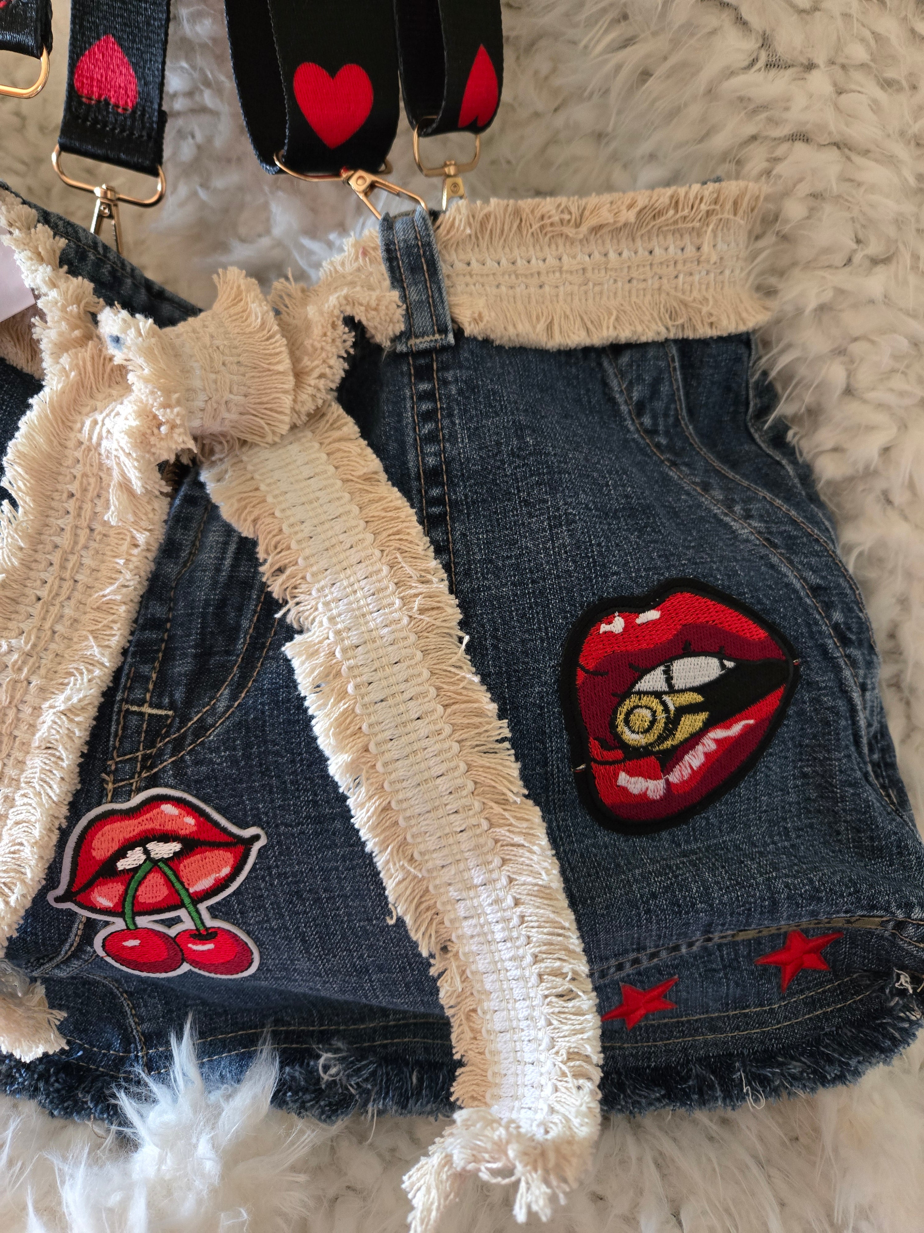 Handmade jean purse with lots of pockets on the outside with lots of red