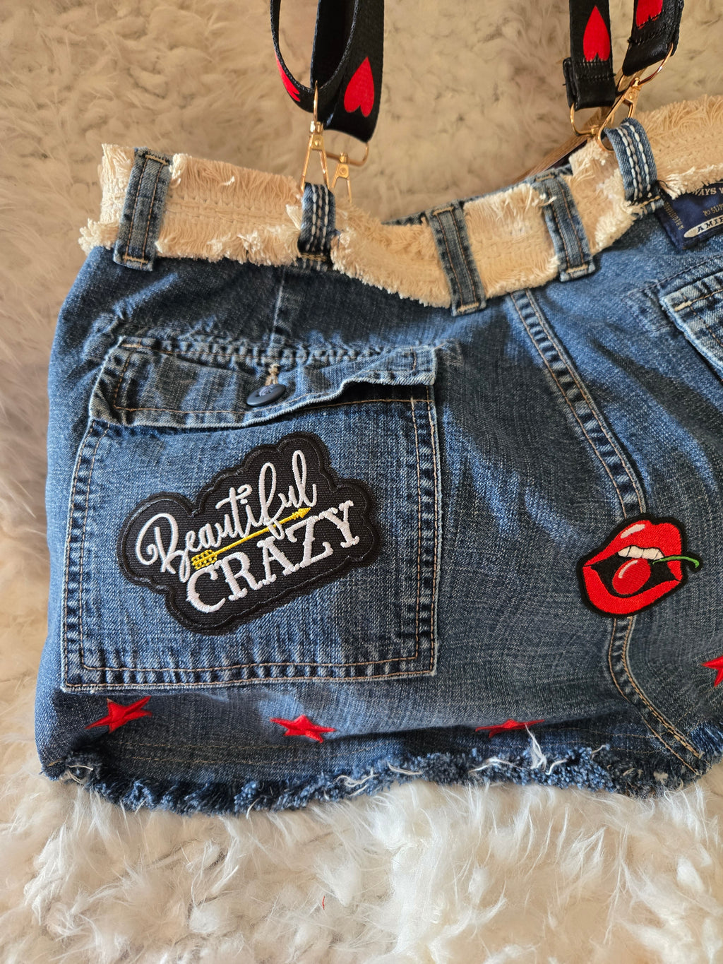 Handmade jean purse with lots of pockets on the outside with lots of red
