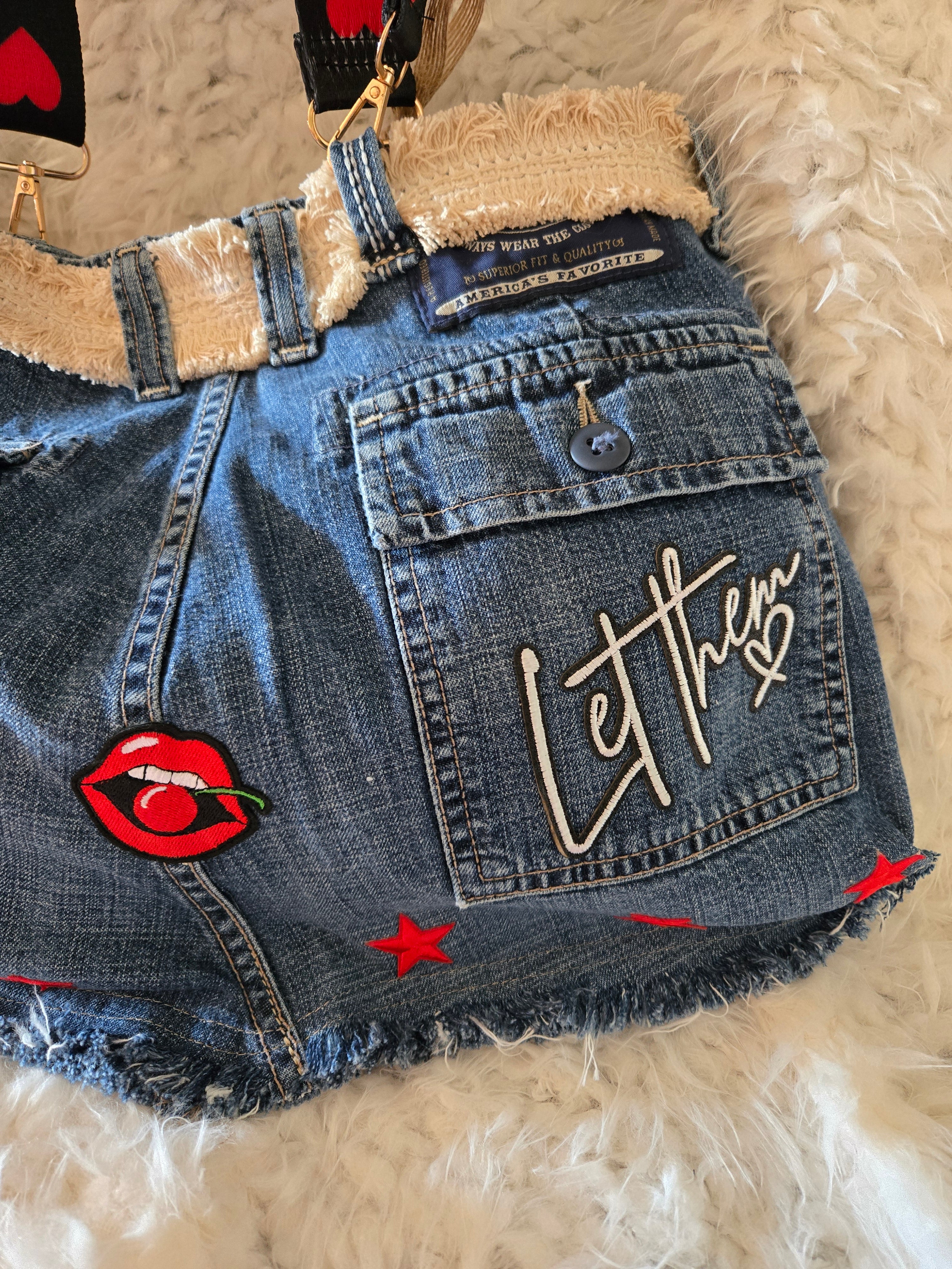 Handmade jean purse with lots of pockets on the outside with lots of red