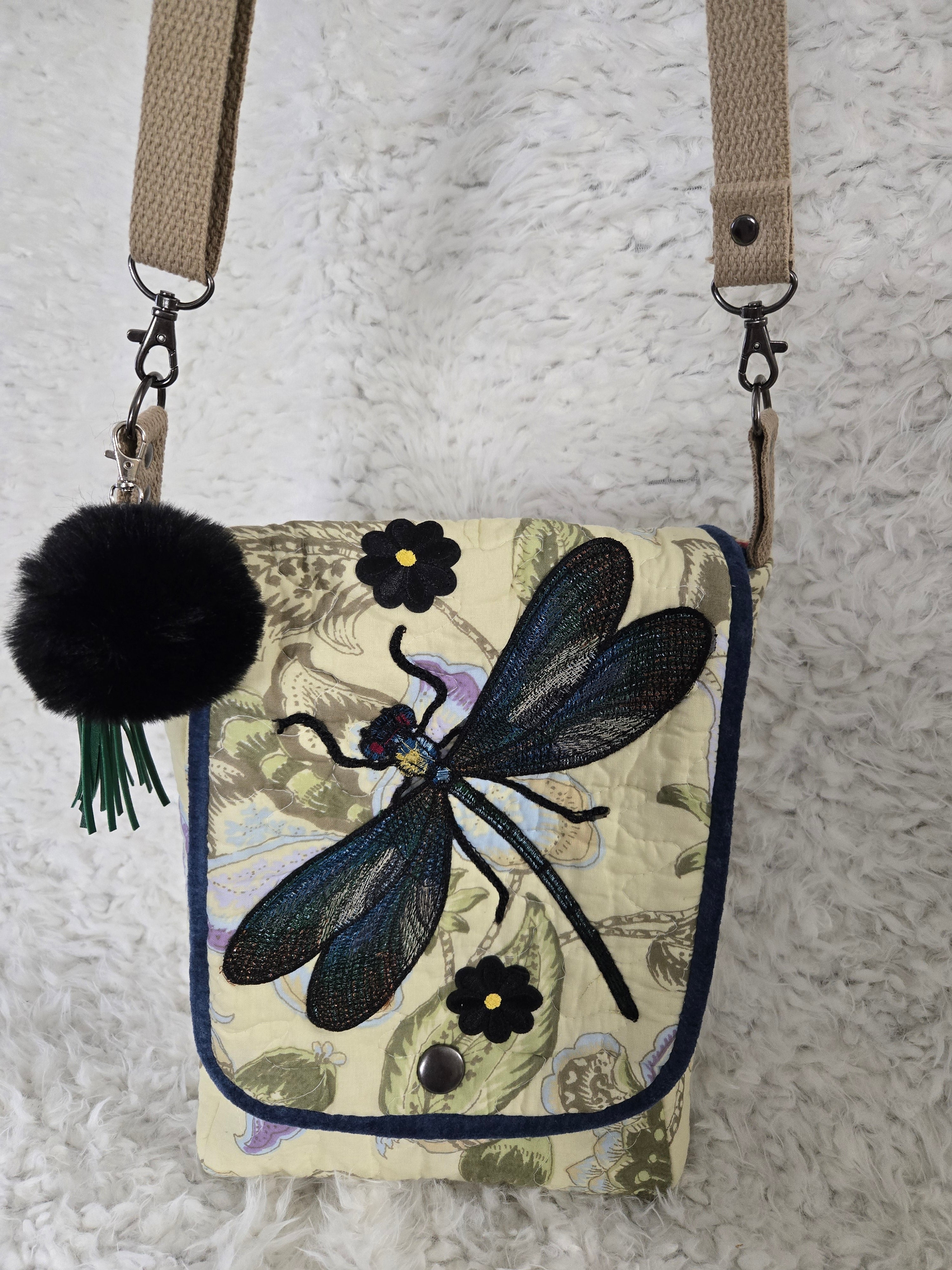 Medium size purse quilted with embroidered dragonfly. On the front with 2 pockets, 1 inside 1 outside yellows and greens and blues. 10x14 crossbody