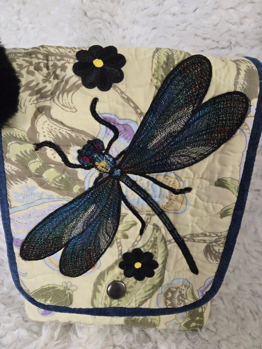 Medium size purse quilted with embroidered dragonfly. On the front with 2 pockets, 1 inside 1 outside yellows and greens and blues. 10x14 crossbody