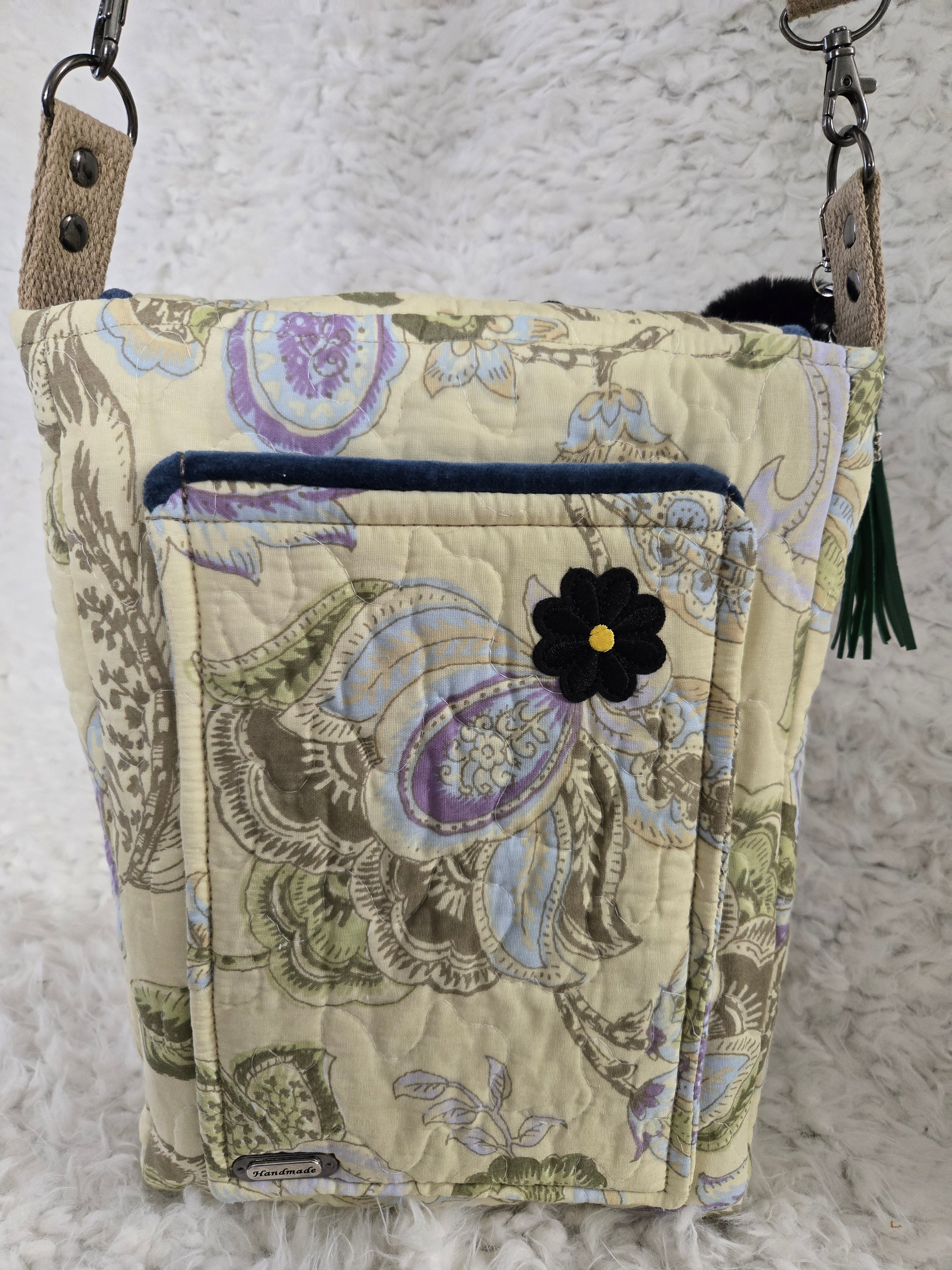 Medium size purse quilted with embroidered dragonfly. On the front with 2 pockets, 1 inside 1 outside yellows and greens and blues. 10x14 crossbody