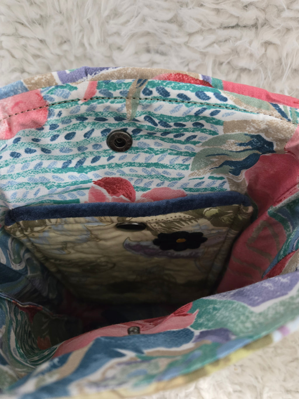 Medium size purse quilted with embroidered dragonfly. On the front with 2 pockets, 1 inside 1 outside yellows and greens and blues. 10x14 crossbody