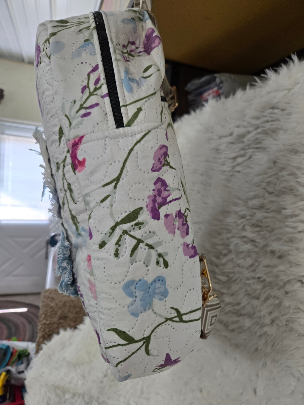 Large backpack made from quilt, has butterfly on the front, two zipper pockets in the back and one pocket on the inside with the key ring