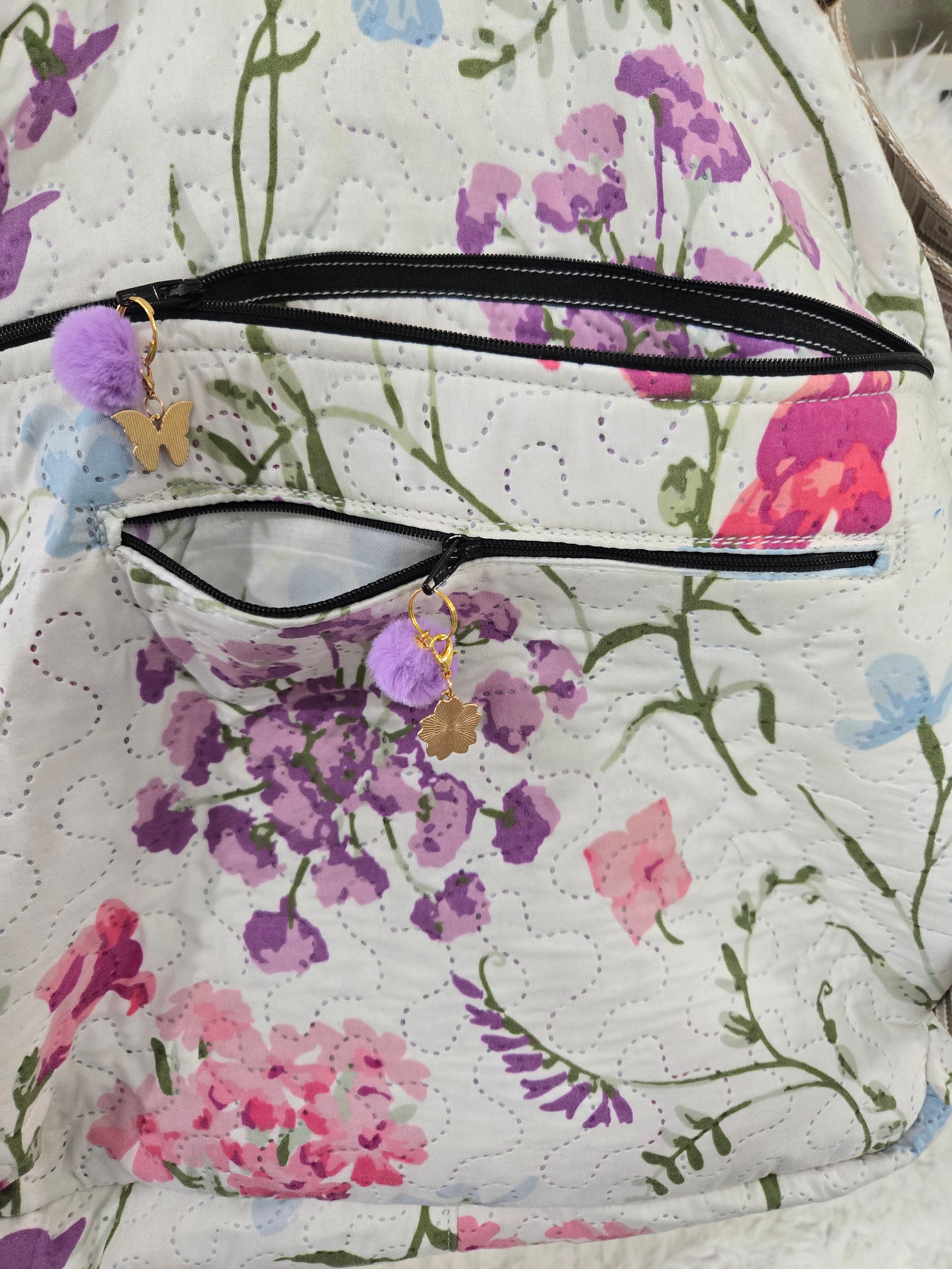 Large backpack made from quilt, has butterfly on the front, two zipper pockets in the back and one pocket on the inside with the key ring