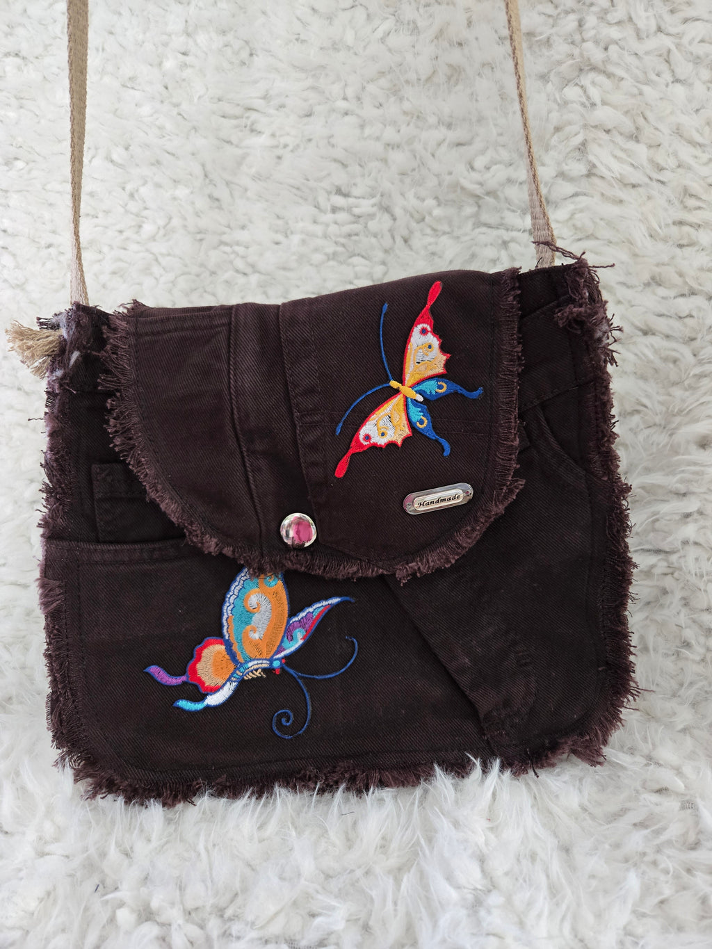 Brown denim, small purse handbag. With butterfly embellishments, vibrantly colored.