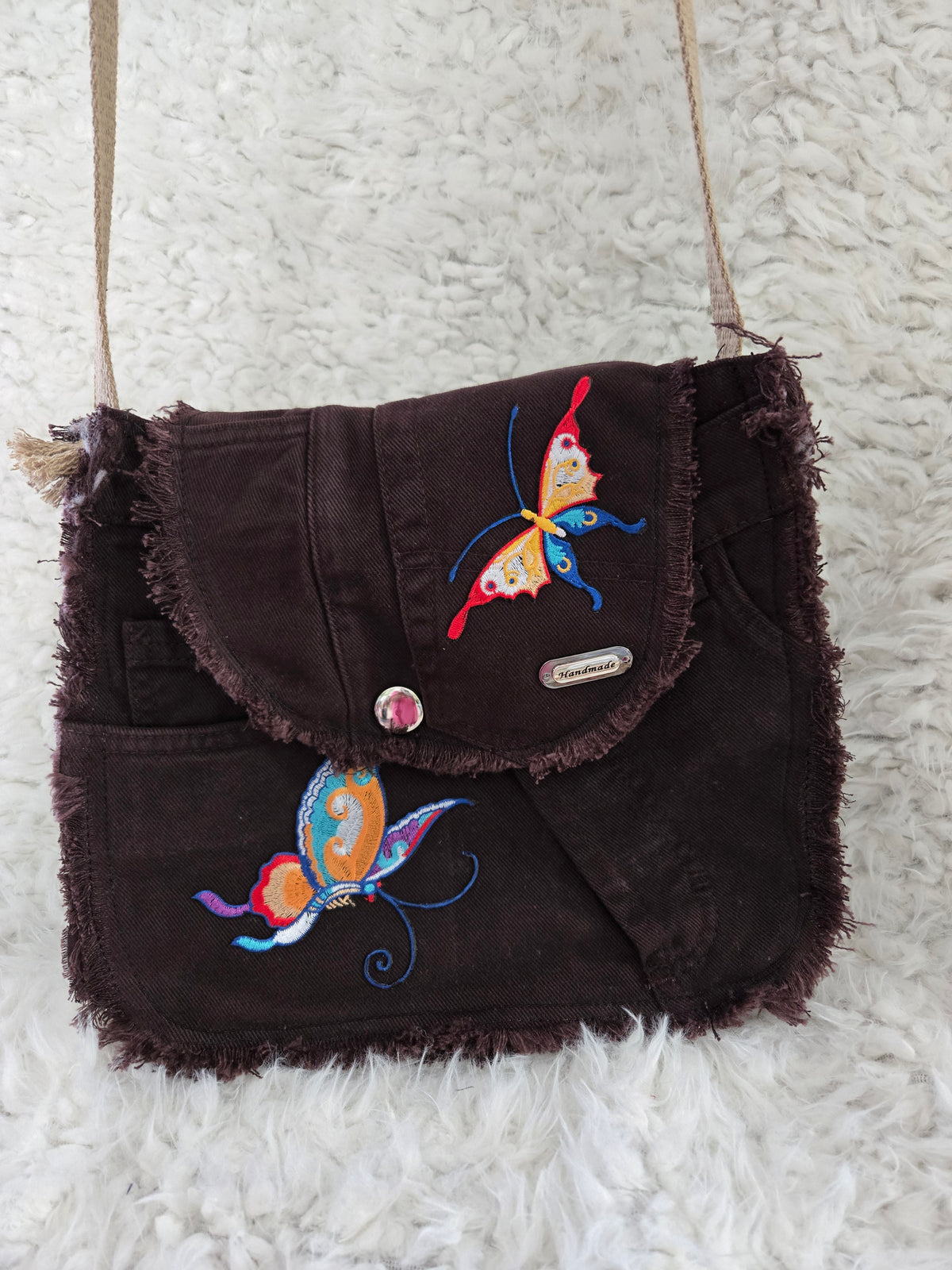 Brown denim, small purse handbag. With butterfly embellishments, vibrantly colored.