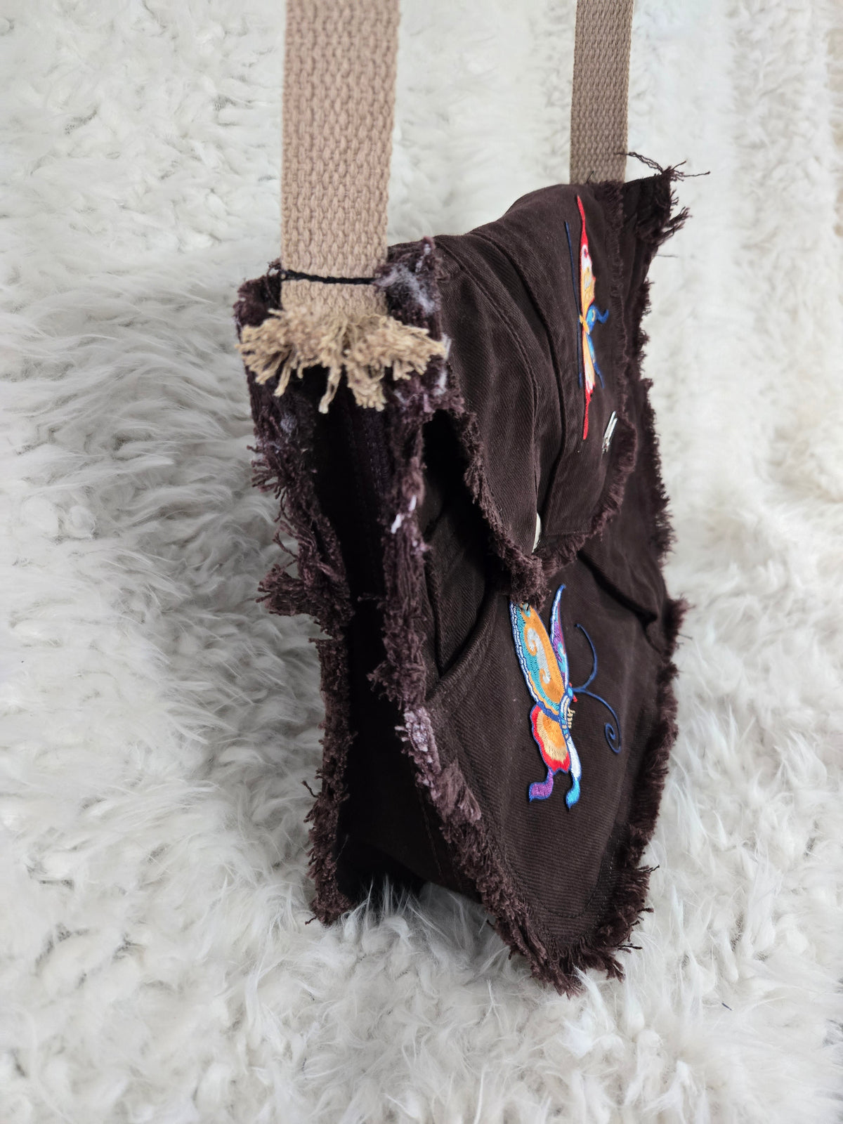 Brown denim, small purse handbag. With butterfly embellishments, vibrantly colored.
