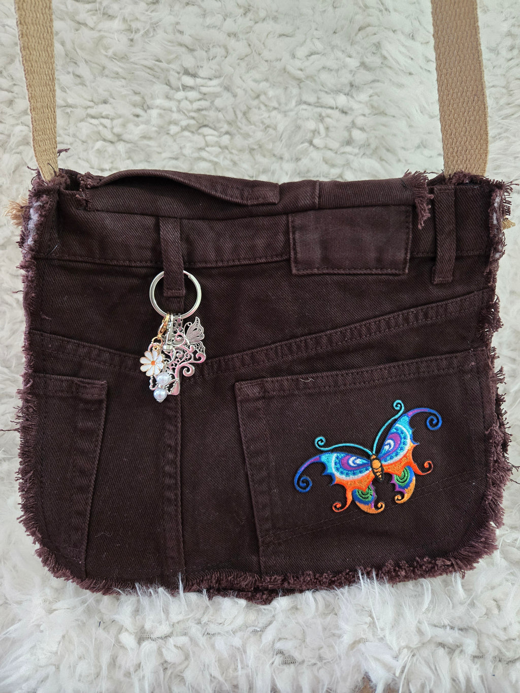 Brown denim, small purse handbag. With butterfly embellishments, vibrantly colored.