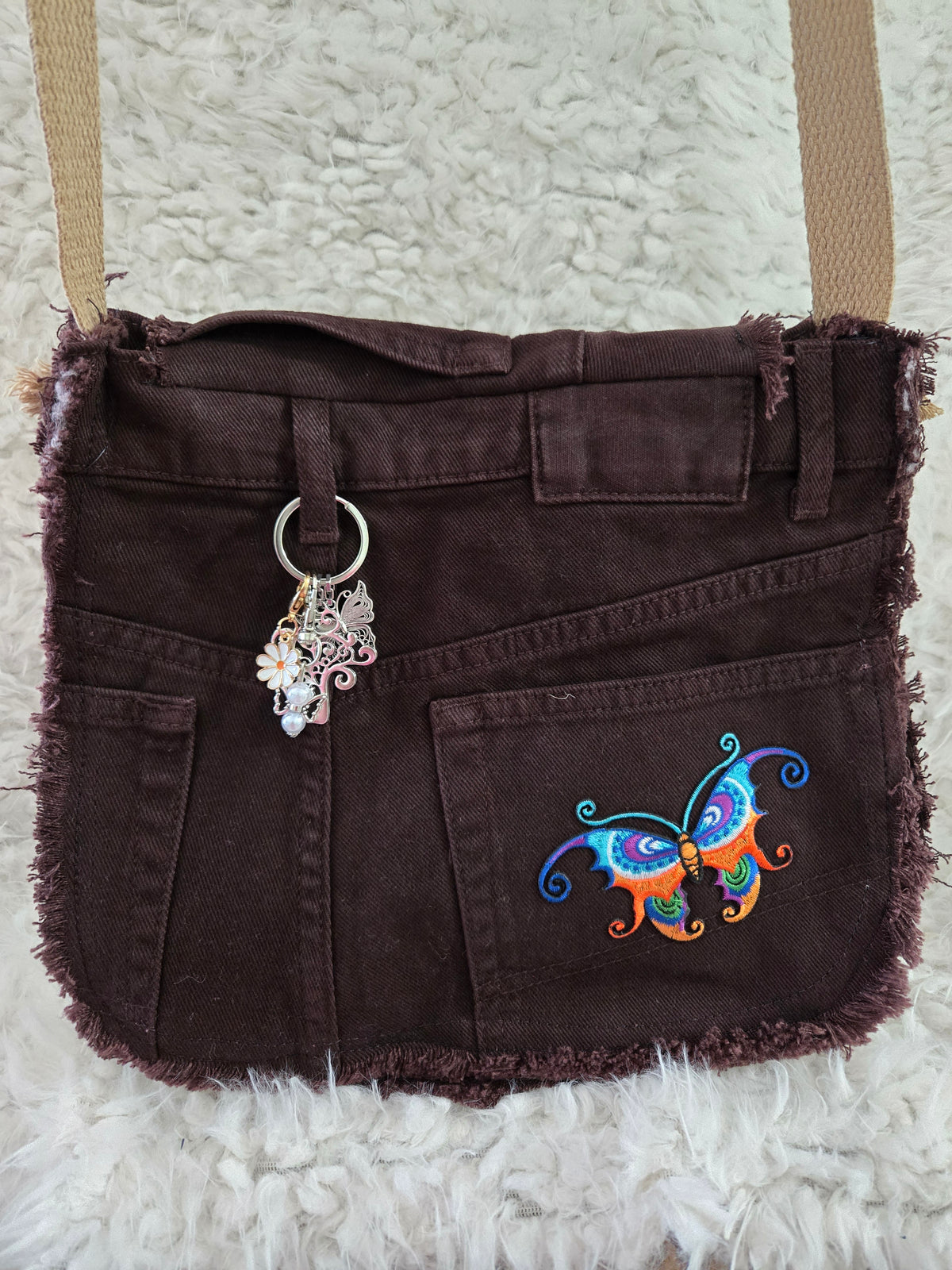 Brown denim, small purse handbag. With butterfly embellishments, vibrantly colored.